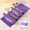 Purple portable detachable makeup bag lying on a white fluffy surface with a small bowl of pearls nearby.