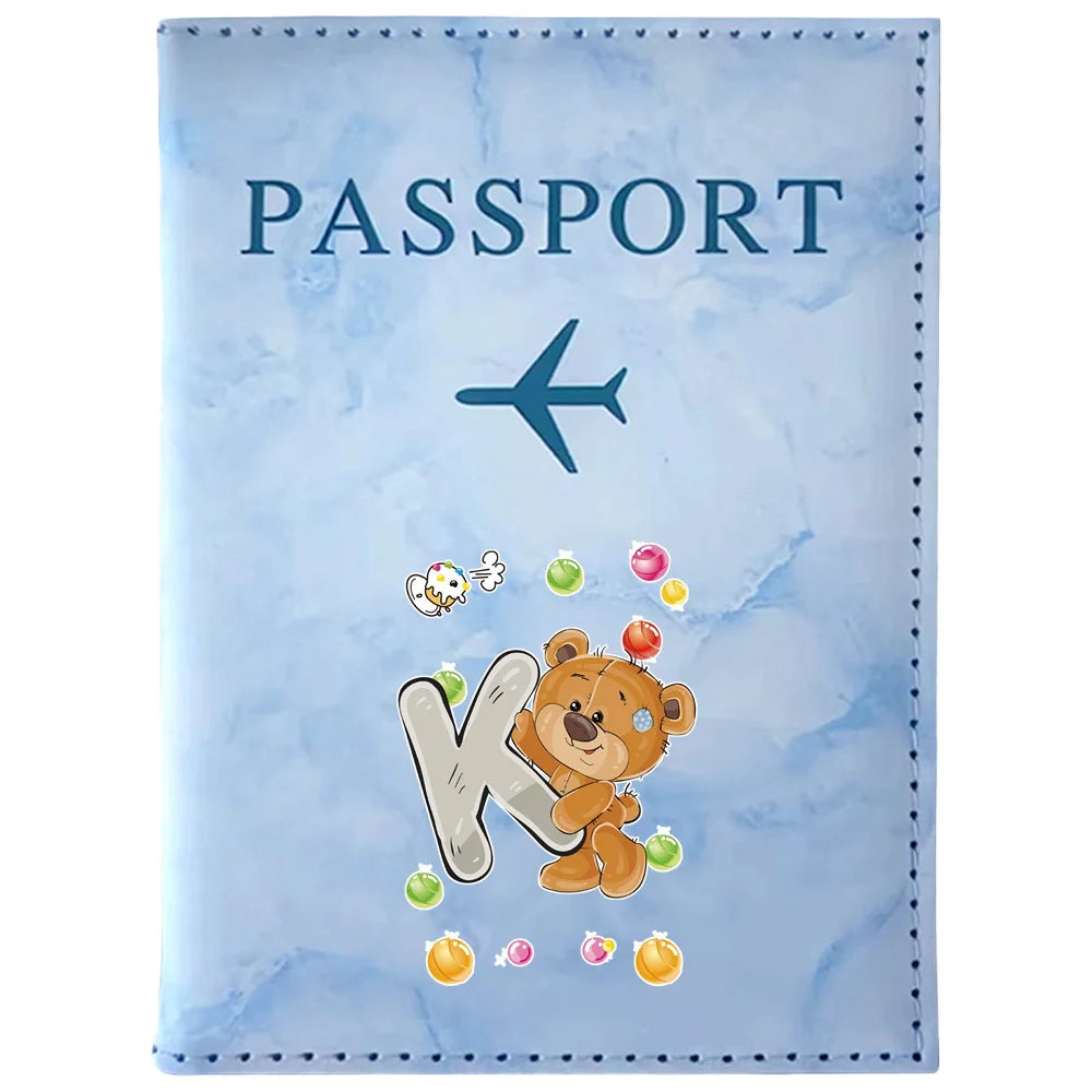 Light blue passport card holder with a vintage letter print featuring an airplane and a bear silhouette.