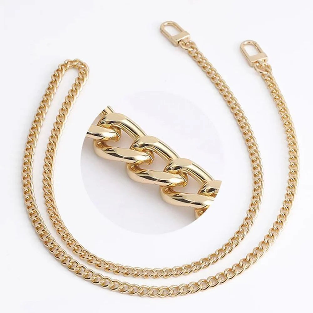 Gold adjustable metal chain handbag straps laid out on a white background.