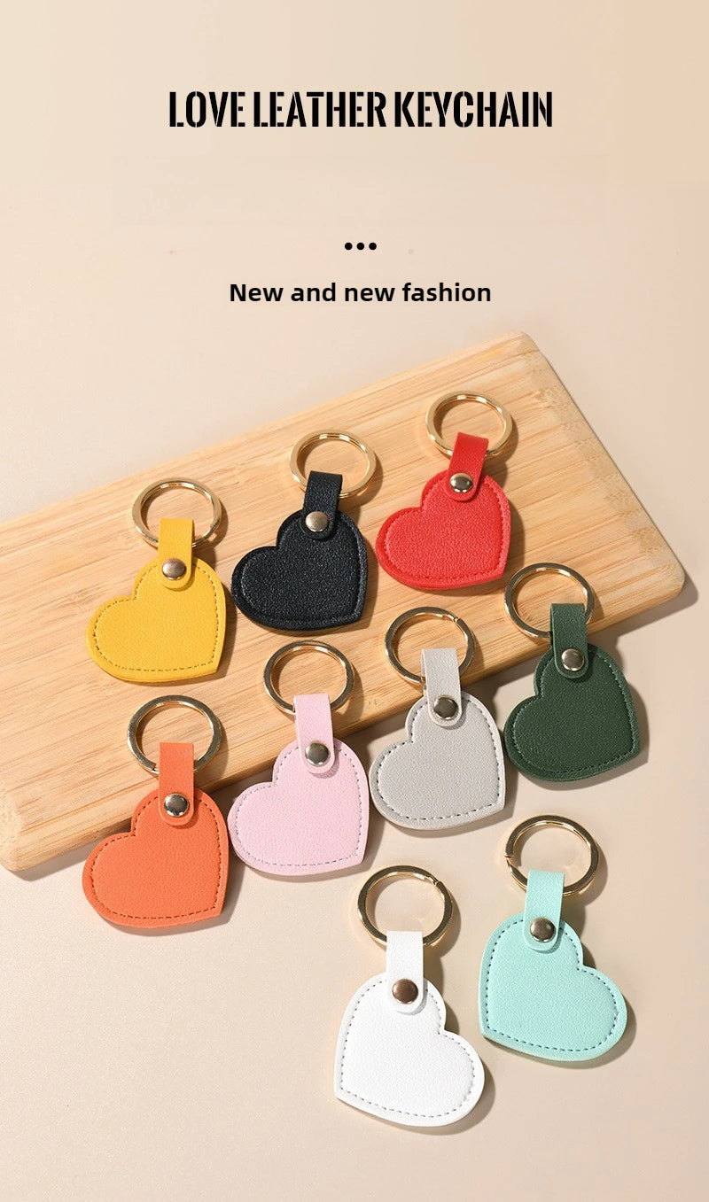 A collection of colorful leather heart keychains displayed on a wooden board.