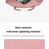 A pink canvas travel storage bag open showing various items like headphones and accessories.