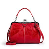 A red leather crossbody shoulder bag with a silver-toned chain strap and a flap closure.