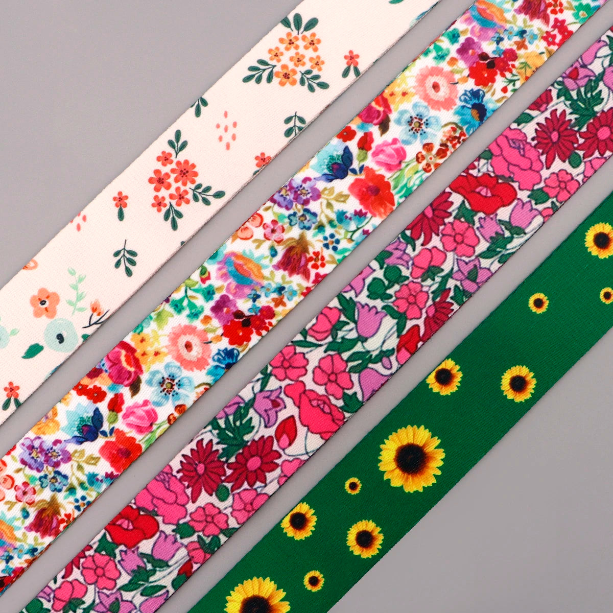 A close-up of a colorful floral pattern fabric strap for an adjustable crossbody bag.