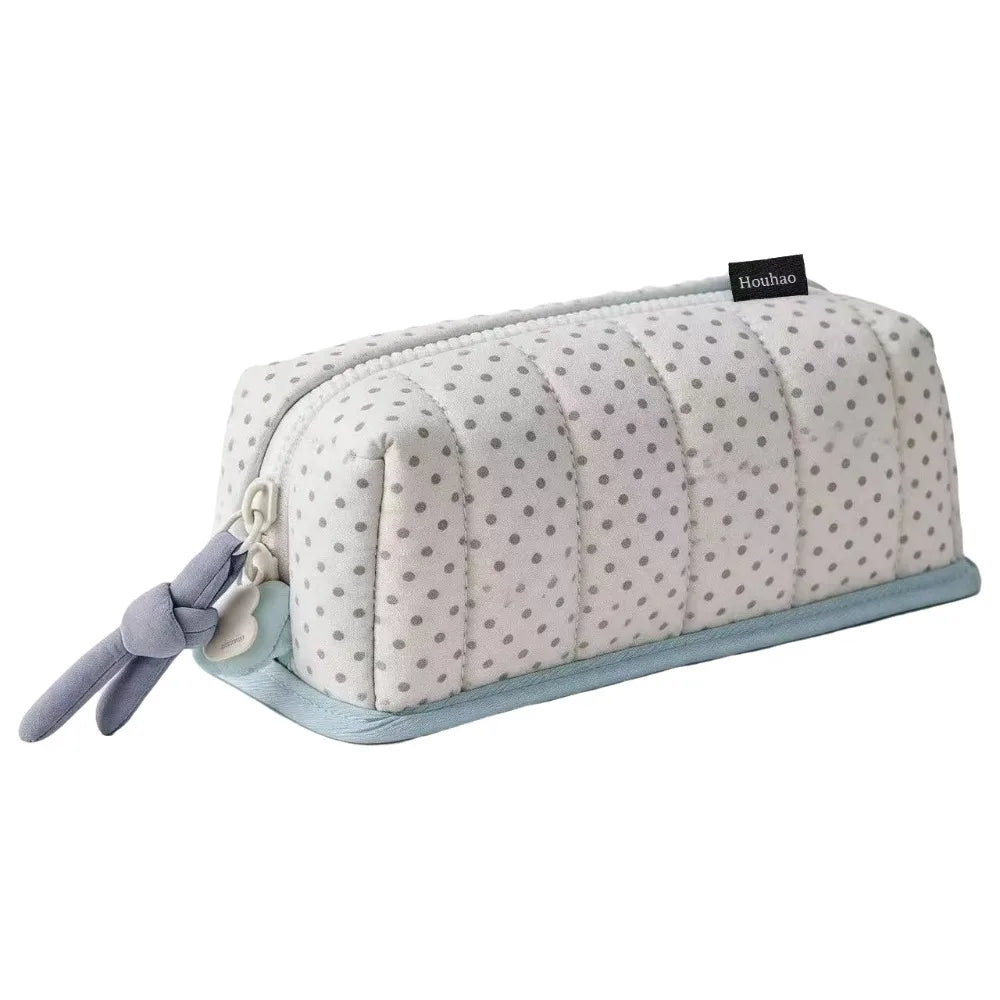 A light gray pencil case with a quilted texture and small gray dots, featuring a light blue trim.