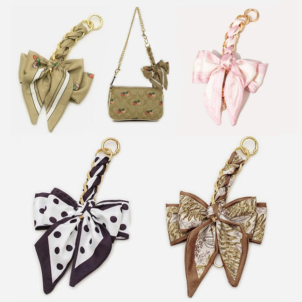 A collection of four bow bag chain strap extensions in various colors and patterns for handbags.