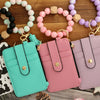 A collection of silicone and PU leather key chain wristlet wallets in various pastel colors, including mint green, pink, and 