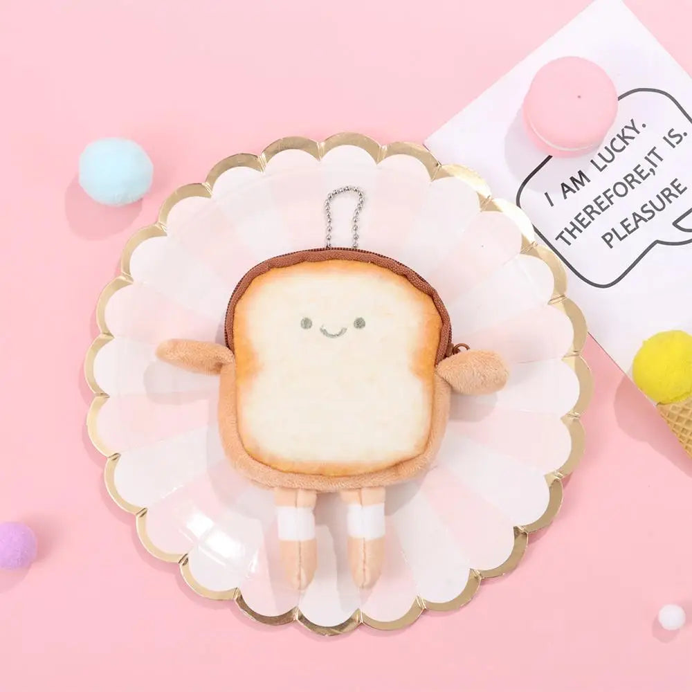 A cute cartoon toast bread plush toy shaped like a coin purse is displayed on a pink plate.