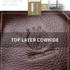 Close-up of genuine top layer cowhide leather texture on a brown messenger bag with an embossed design.