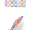 A colorful patchwork cosmetic storage pouch featuring squares of pink, yellow, blue, and white.