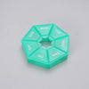 A teal weekly pill organizer divided into seven sections labeled SUN, MON, TUE, WED, THU, FRI, SAT, and a separate section fo
