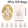 Set of six light pink drawstring gift bags featuring embroidered Easter bunny designs on a pale pink fabric.