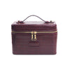 A maroon PU leather makeup bag with a gold zipper and leather trim.