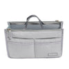 A gray fabric handbag organizer insert with a handle and multiple pockets.