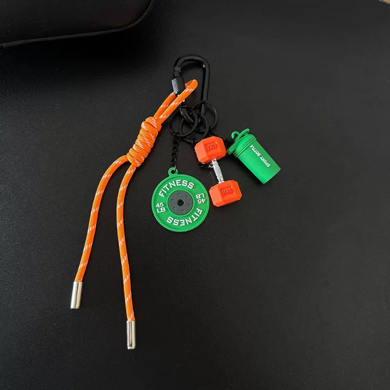 Orange D-shape nylon fitness keychain with a fitness weight and green clip.