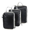 A set of black and gray reusable compression packing cubes with fabric handles.