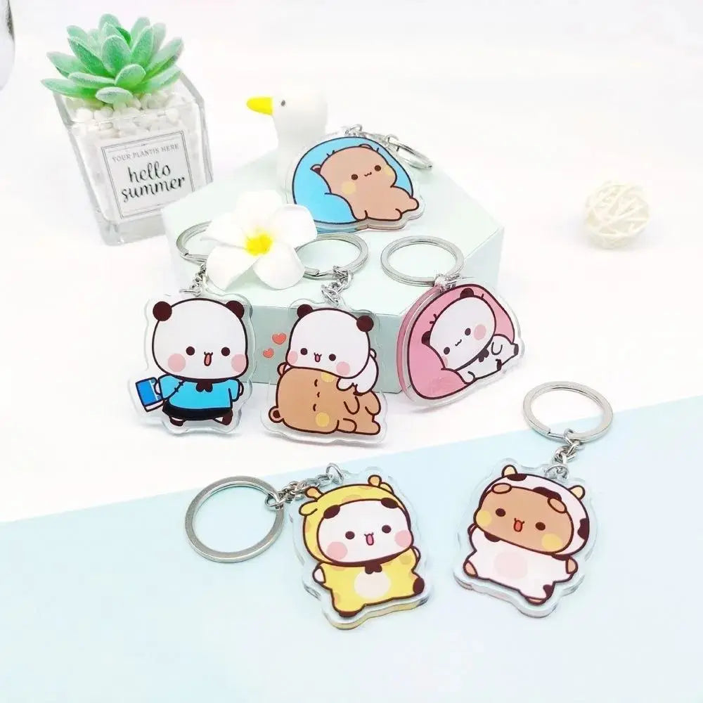 A collection of cute cartoon resin keychain charms featuring characters like a bear and a cat, displayed on a white surface.