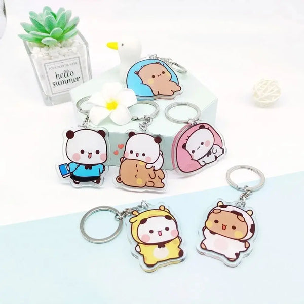 A collection of cute cartoon resin keychain charms featuring characters like a bear and a cat, displayed on a white surface.