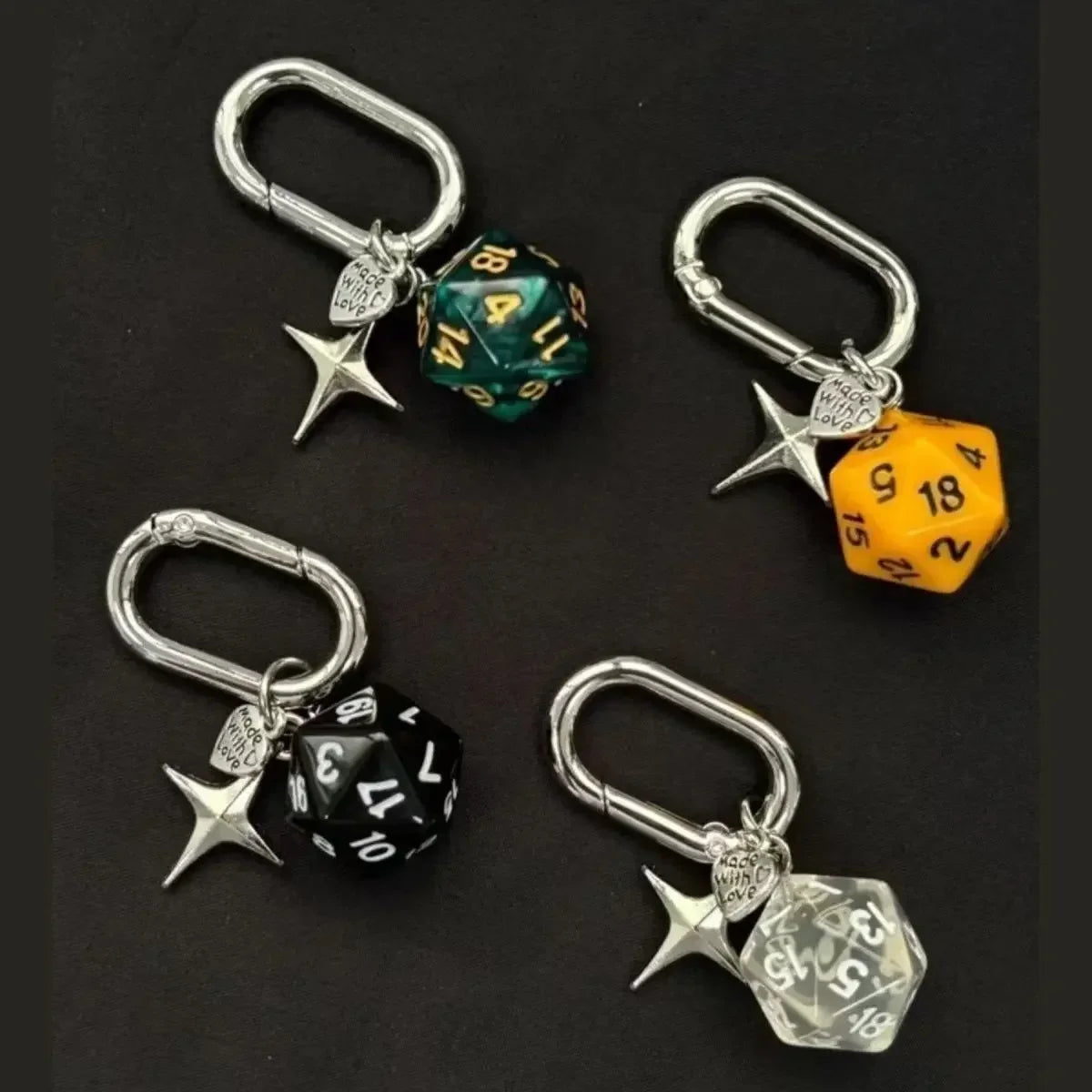 A set of resin dice keychains featuring various colors and designs like green, yellow, and black.