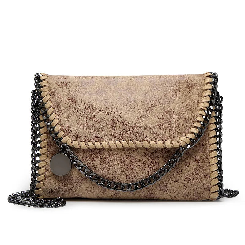 A vintage brown faux leather flap crossbody bag with a silver chain strap.