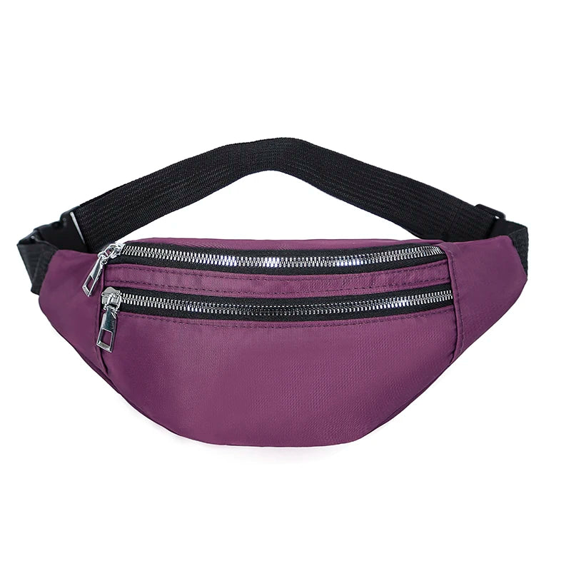 A purple nylon crossbody sling bag with a black adjustable strap and a zippered front pocket.