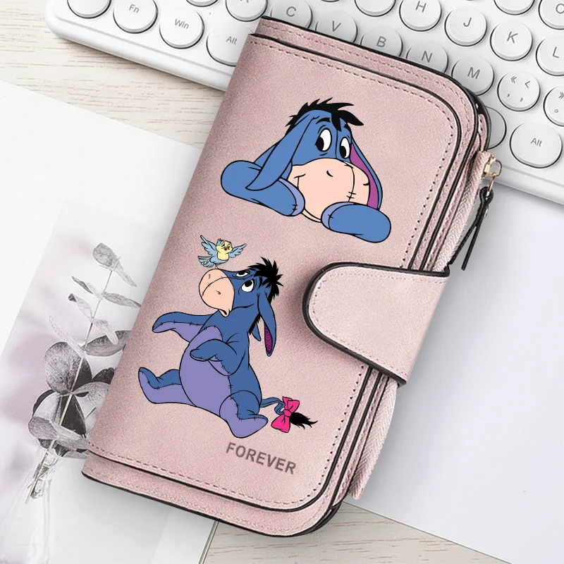 A pink women's long zipper handbag coin purse featuring illustrations of blue cartoon ponies.