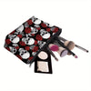 A black makeup pouch featuring a pattern of skulls and red roses, with makeup brushes inside.