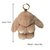 A light brown plush rabbit fur keychain with a gold-colored ring.