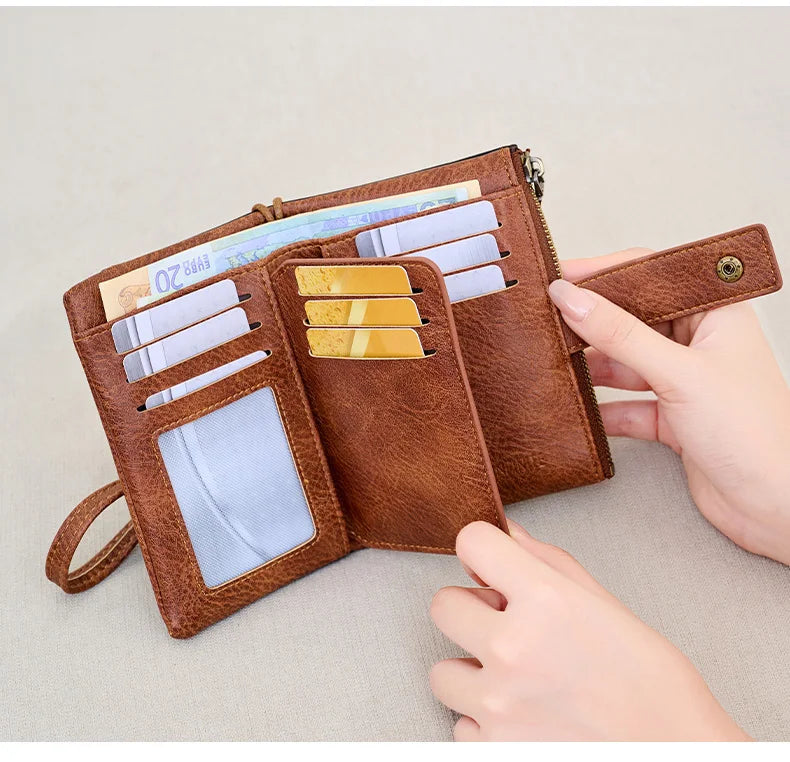 A brown leather multi-slot wallet with RFID blocking features is shown open, displaying various cards and cash.