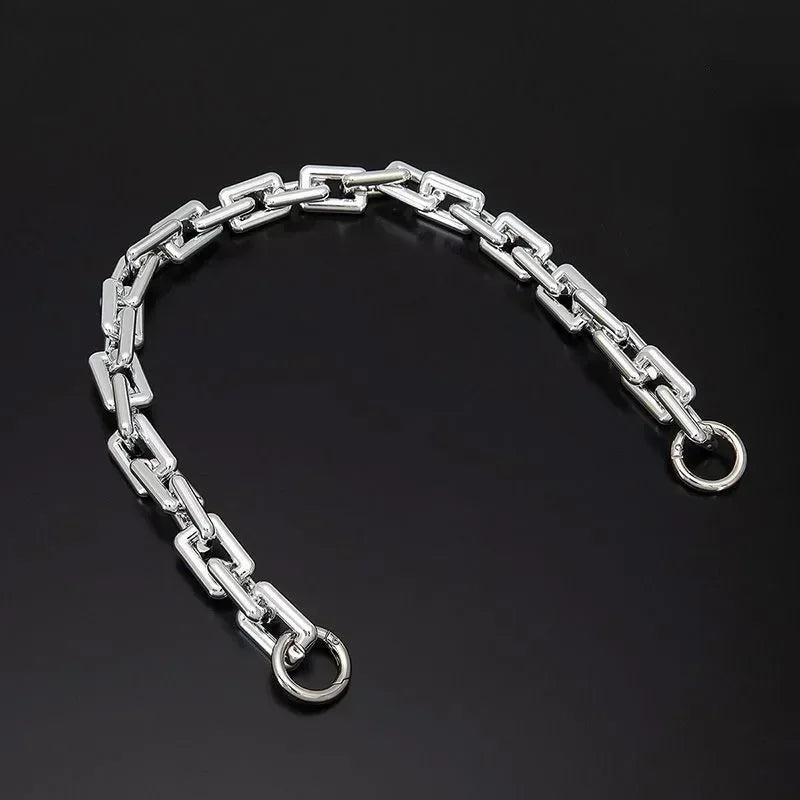 Silver acrylic purse chain strap for shoulder bags displayed against a dark background.