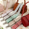 A collection of adjustable nylon shoulder straps in various patterns and colors laid out on a white surface.