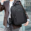 A person is holding a black unisex double-shoulder travel backpack while wearing a brown leather jacket and light shirt.