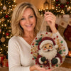 A woman holds a finished pearl diamond painting suncatcher kit with a lace edge.