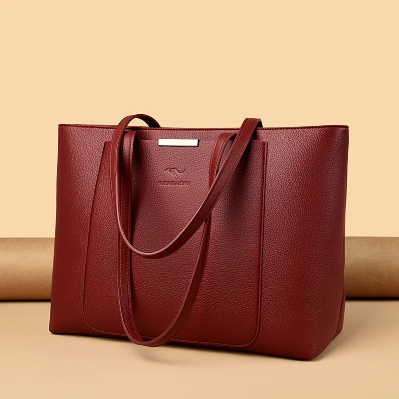 A deep burgundy leather shoulder bag with a smooth texture and a silver logo tag, displayed on a neutral background.