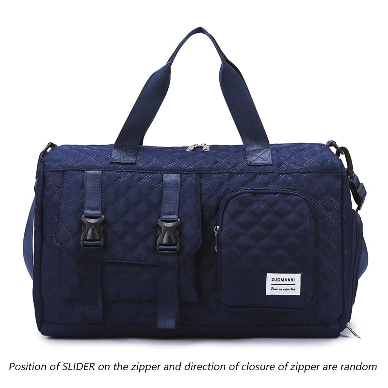 Navy nylon travel duffle bag with a quilted argyle pattern and dark handles