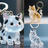 A clear glass cat figurine with gold accents is shown as a keychain pendant.
