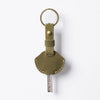 A genuine leather key fob cover with a keychain ring and a metal key attached.