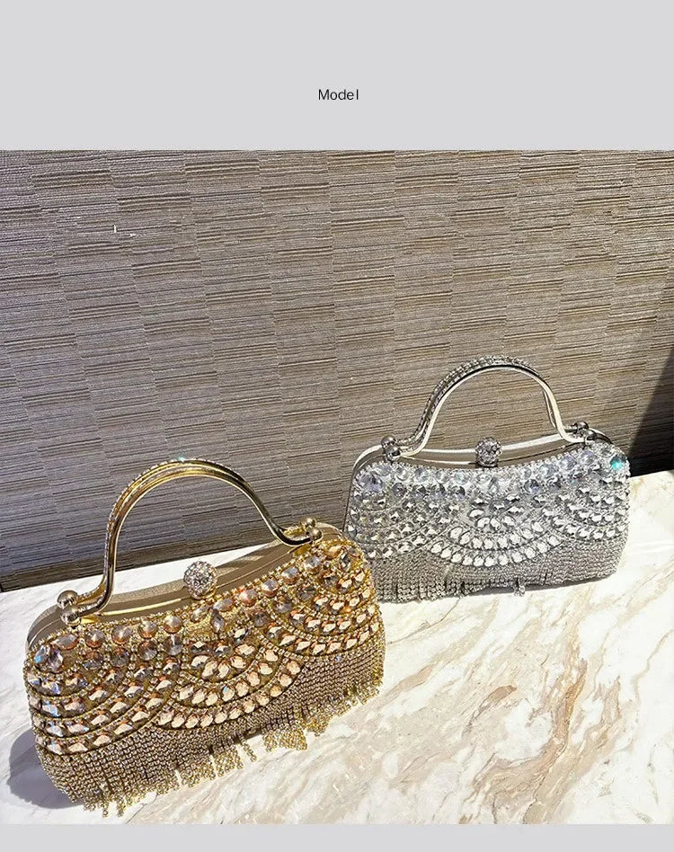 An elegant diamond rhinestone evening clutch bag with a golden tassel resting on a marble surface.