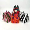 Three retro knitted bucket handbags in striped and solid colors displayed on a white surface.