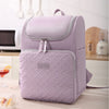 A light purple insulated picnic cooler backpack is shown resting on a table.