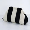 A beige and black striped crochet handbag shown from the side.
