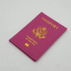 A magenta leather passport holder featuring a gold embossed eagle design and the text United States of America.