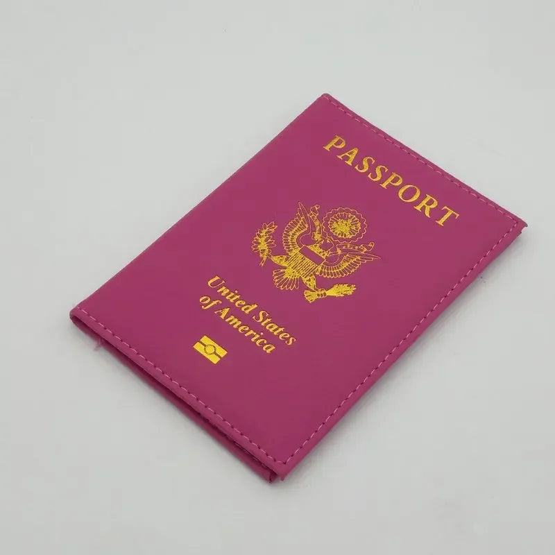 A magenta leather passport holder featuring a gold embossed eagle design and the text United States of America.