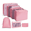 A set of pink fabric storage organizers and pouches for organizing various items.