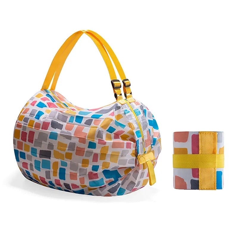 A colorful foldable nylon storage bag with a yellow handle and striped pattern.