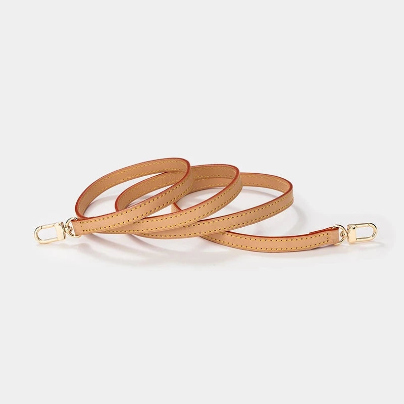 A set of genuine Vachetta leather handbag straps with gold-tone buckles.