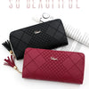 A close-up of a black quilted clutch wallet and a maroon quilted clutch wallet with gold chain details.