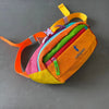An orange and pink patchwork color block fanny pack with a yellow strap.