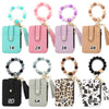 Eight numbered leather card holders in various colors and leopard print patterns with gold keychains and bangles