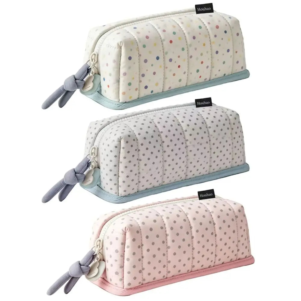 A set of three soft fabric pencil cases featuring a creative dot pattern in pastel colors for school and office use.