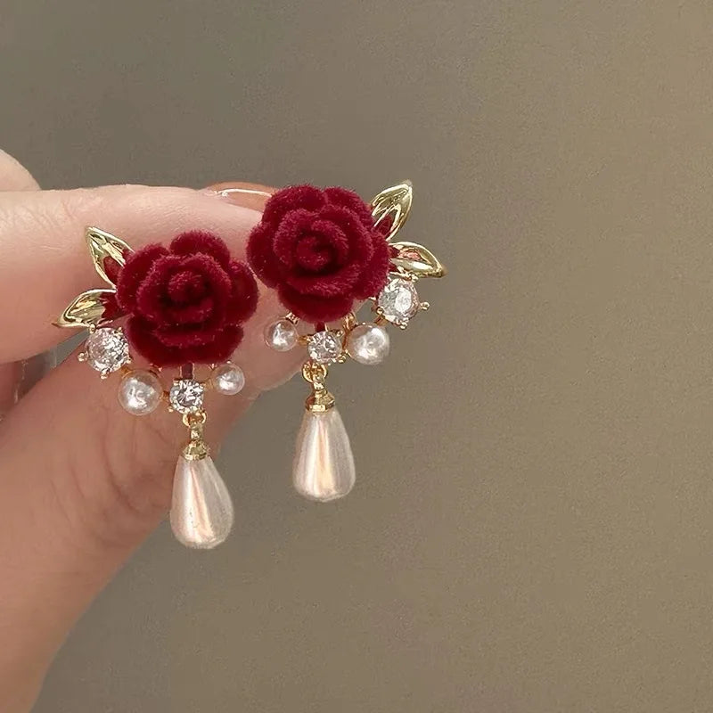 Gold-toned velvet rose earrings with clear and pearl accents